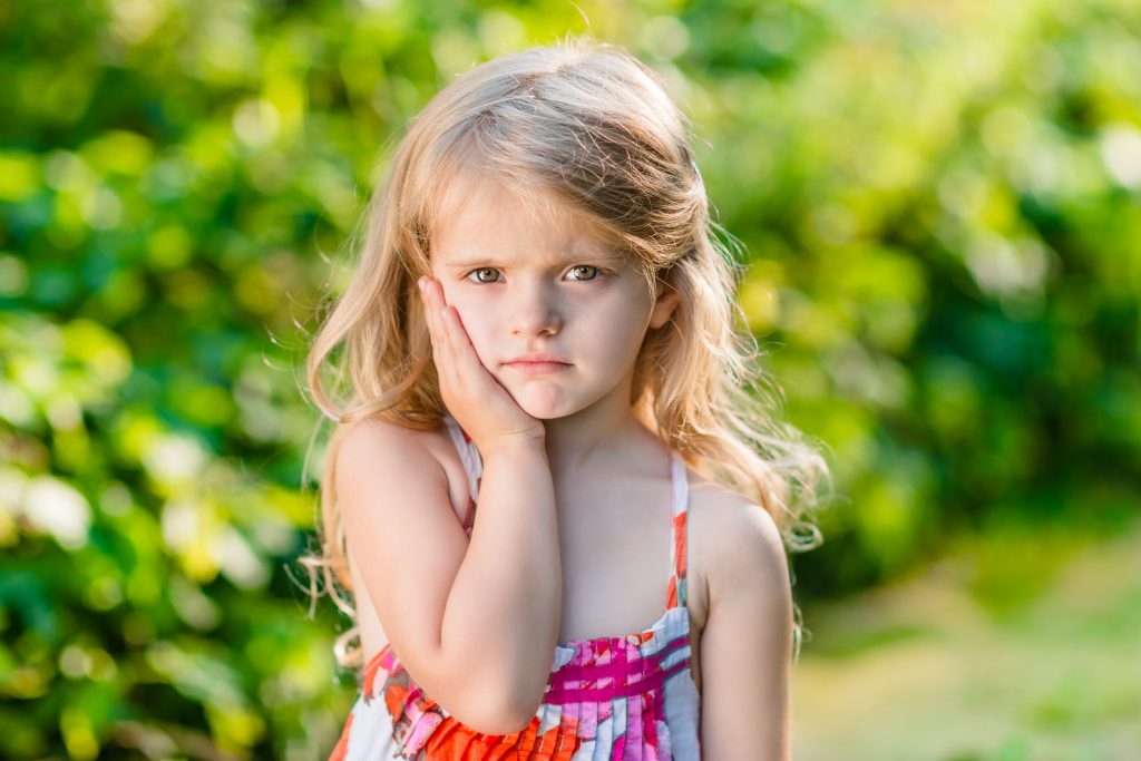 Sad Little Girl With Long Blond Hair Suffering From Toothache